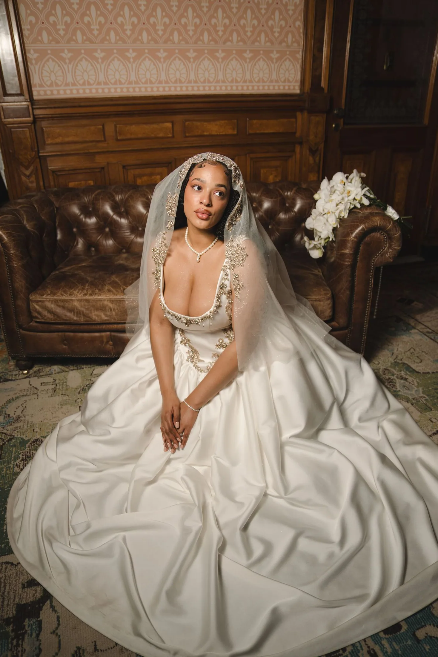 Bride seated in her gown for an editorial wedding portrait