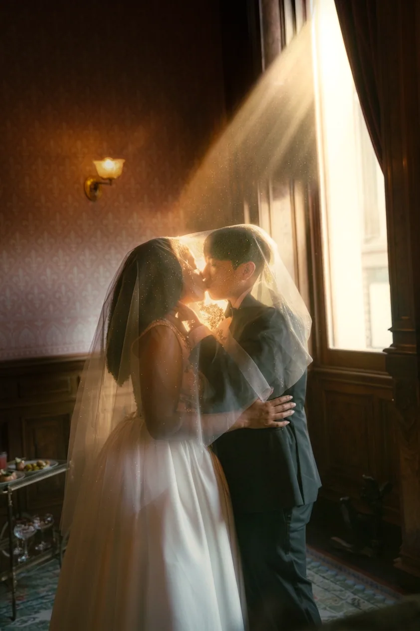 Newlyweds sharing a quiet moment in warm window light
